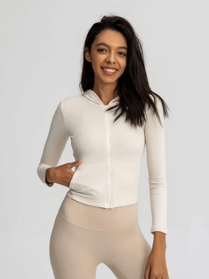 Woman wearing sports zipper jacket with long sleeves and hood, perfect for outdoor activities and active women, SF1814.